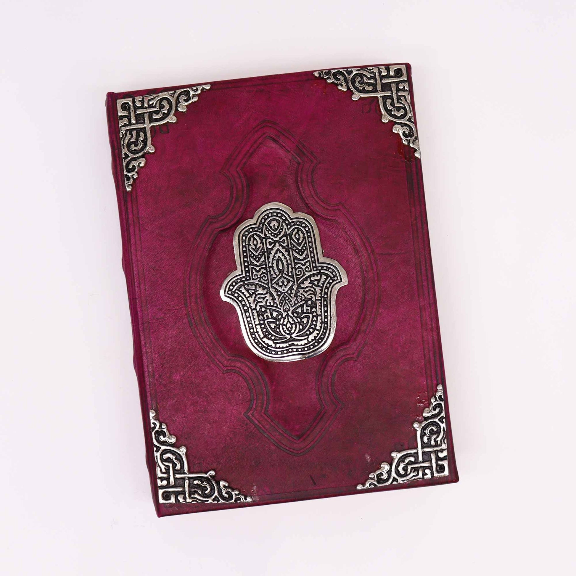 Decorative red book with silver Hamsa design on a white background