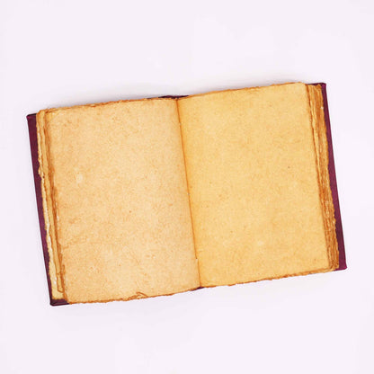 Open book with yellowed pages on a white background