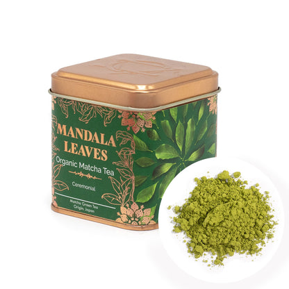 Mandala Leaves 50g ceremonial matcha tea in a green and gold tin with a pile of vibrant green matcha powder.